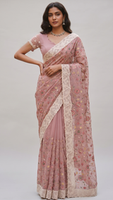 Model wearing a pink Vasundhara Fashions chiffon saree with intricate floral Chikankari embroidery and scalloped blouse