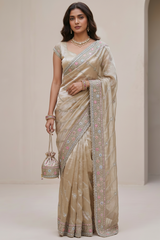 Vasundhara Fashions beige organza saree with intricate floral embroidery and matching designer blouse on a model