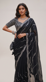 Vasundhara Fashions black soft organza saree with intricate silver sequin embroidery and matching embellished blouse