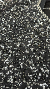 Vasundhara Fashions black soft organza saree featuring intricate silver sequin and bead embroidery detail