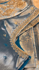 Vasundhara Fashions blue Kanchipuram pattu silk saree with intricate silver jari embroidery and beadwork details.