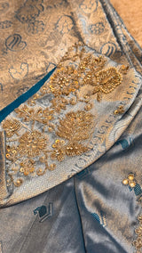 Vasundhara Fashions light blue Kanchipuram pattu silk saree with intricate silver zari and floral beadwork embroidery