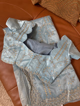 Vasundhara Fashions blue tissue saree with intricate silver and gold floral embroidery and scalloped blouse edges