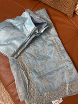 Vasundhara Fashions light blue tissue saree with intricate gold embroidery and matching blouse piece