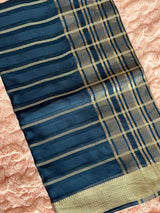Vasundhara Fashions blue tissue saree with maroon contrast, gold striped patterns, and a traditional zari border.