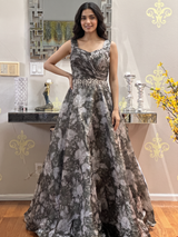 Vasundhara Fashions bottle green organza long gown with floral digital print, pleated bodice, and embellished waist.