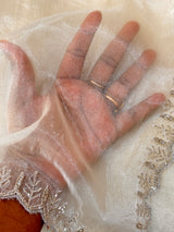 Vasundhara Fashions cream tissue saree fabric with delicate silver beaded embroidery and sheer texture