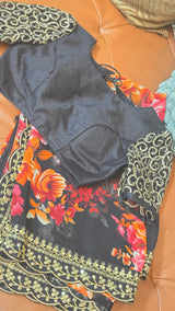 Vasundhara Fashions black chiffon saree with vibrant floral print and gold sequin border, paired with embellished blouse