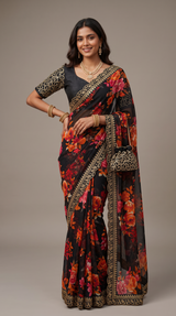 Vasundhara Fashions black chiffon saree with vibrant floral print and gold sequin border, paired with embellished blouse