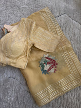 Vasundhara Fashions gold Kora saree with silver gota patti embroidery and a matching blouse on a textured rug