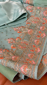 Vasundhara Fashions green crepe saree featuring intricate floral embroidery with pink thread and metallic beadwork.