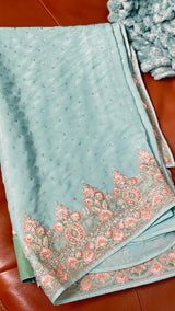 Vasundhara Fashions light green crepe saree featuring intricate floral embroidery and silver sequin embellishments.