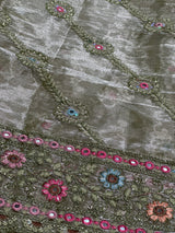 Vasundhara Fashions green organza saree featuring intricate floral embroidery with pink and blue threadwork and mirrors.