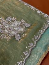 Vasundhara Fashions green organza saree featuring intricate silver sequin and bead floral embroidery on the border.