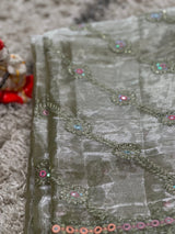 Vasundhara Fashions green organza saree featuring intricate floral embroidery with shimmering mirror work details