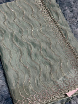 Vasundhara Fashions sage green organza saree with intricate silver sequin wave embroidery and a decorative border