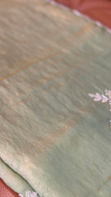 Vasundhara Fashions green soft organza saree featuring delicate white floral embroidery and a subtle sheen