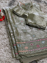 Vasundhara Fashions green organza saree featuring intricate floral embroidery and a matching designer blouse.