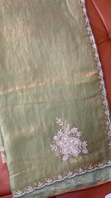 Vasundhara Fashions green organza saree with intricate silver floral embroidery and a decorative scalloped border.