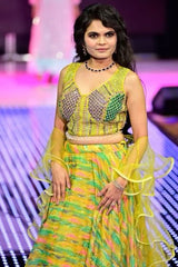 Vasundhara Fashions green printed organza lehenga with a sleeveless embellished blouse and ruffled swirl dupatta.