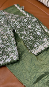 Vasundhara Fashions green crush Russian silk saree featuring a heavily embellished blouse with silver sequin work.
