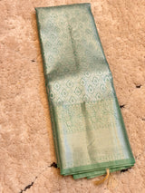 Vasundhara Fashions light green Kanchipuram pattu silk saree with intricate silver zari paisley and floral motifs.