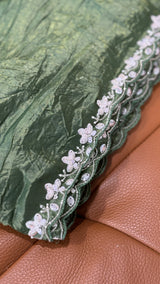 Vasundhara Fashions green crush Russian silk saree featuring an intricate white floral sequin and bead border