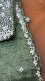 Vasundhara Fashions green crush Russian silk saree featuring intricate white floral embroidery and sequin detailing.