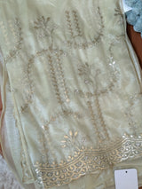 Vasundhara Fashions light green tissue saree featuring intricate gold embroidery and delicate sequin embellishments