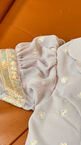 Vasundhara Fashions lavender saree blouse sleeve with intricate Chikankari embroidery, sequins, and mirror work border.