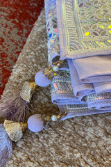 Vasundhara Fashions lavender saree with intricate Chikankari embroidery, mirror work, sequins, and elegant tassels.