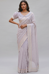 Model wearing a Vasundhara Fashions lavender Chikankari saree with mirror work border and scalloped puff sleeve blouse