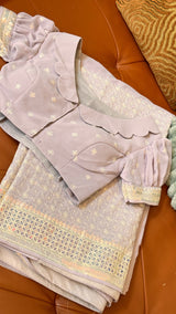 Vasundhara Fashions lavender saree with intricate Chikankari embroidery, mirror work border, and scalloped puff blouse.