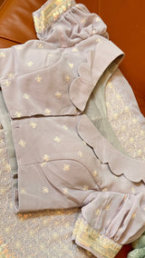 Vasundhara Fashions lavender Chikankari saree with intricate embroidery, scalloped blouse, and sequin mirror border.