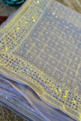 Vasundhara Fashions lavender saree with intricate Chikankari embroidery and a shimmering mirror and sequin border.