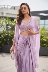 Vasundhara Fashions lavender crop top with embroidered bodice, matching draped skirt, and sheer cape on a model.