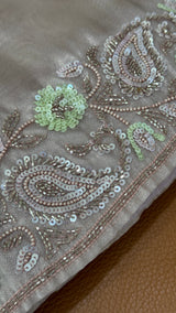 Close-up of Vasundhara Fashions lavender tissue netted saree featuring intricate silver sequin and bead embroidery
