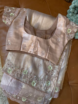 Vasundhara Fashions lavender tissue netted saree with intricate sequin and thread embroidery on the blouse and border.