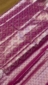 Vasundhara Fashions magenta Kanchipuram pattu silk saree featuring intricate silver zari floral and paisley patterns.