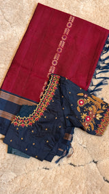 Vasundhara Fashions maroon Uppada Pattu silk saree paired with a navy blue blouse featuring intricate floral embroidery