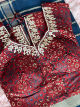 Vasundhara Fashions maroon tissue saree blouse with intricate gold embroidery and blue geometric print patterns