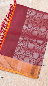 Vasundhara Fashions maroon Uppada Pattu silk saree with intricate silver zari floral motifs and a bright yellow border.