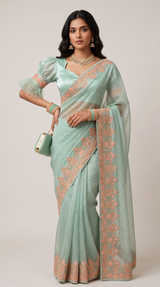 Vasundhara Fashions mint green crepe saree with peach floral embroidery and a matching blouse with ruffled sleeves