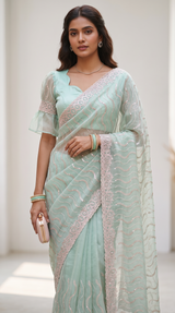 Vasundhara Fashions mint green organza saree with intricate wave embroidery and a matching stitched blouse