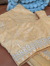 Vasundhara Fashions mustard organza saree featuring intricate silver sequin embroidery and a matching stitched blouse