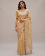 Model wearing a Vasundhara Fashions mustard organza saree with silver embroidery and a matching stitched blouse