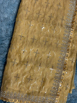 Vasundhara Fashions mustard organza saree with intricate gold embroidery, sequin detailing, and a scalloped border.