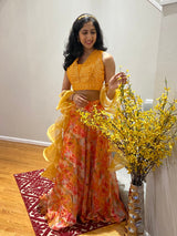 Vasundhara Fashions orange organza croptop lehenga with digital floral print and ruffled dupatta worn by a woman.