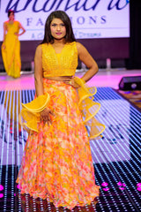 Vasundhara Fashions orange organza croptop lehenga with digital floral print and ruffled yellow dupatta on a runway