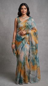 Vasundhara Fashions organza saree with mustard and teal watercolor print and a stone-studded diamond border.